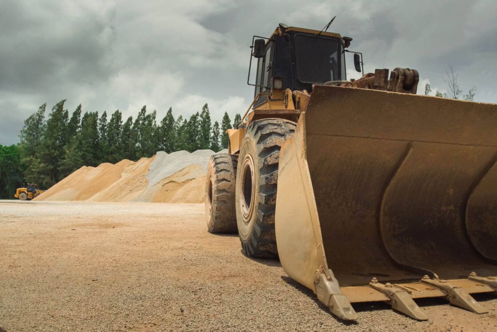 Wheel loader moving sand and gravel.